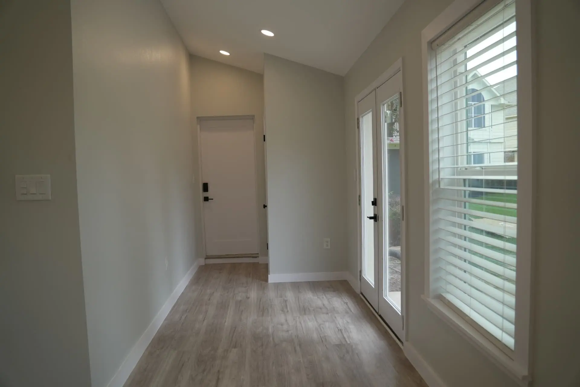 Hallway with French doors leading to the backyard