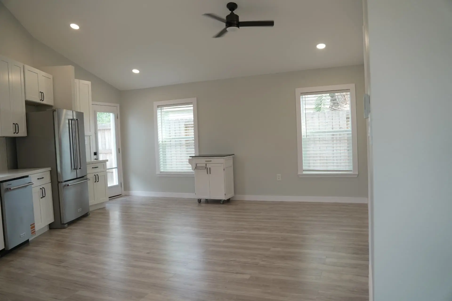 Living and kitchen area with ceiling fan