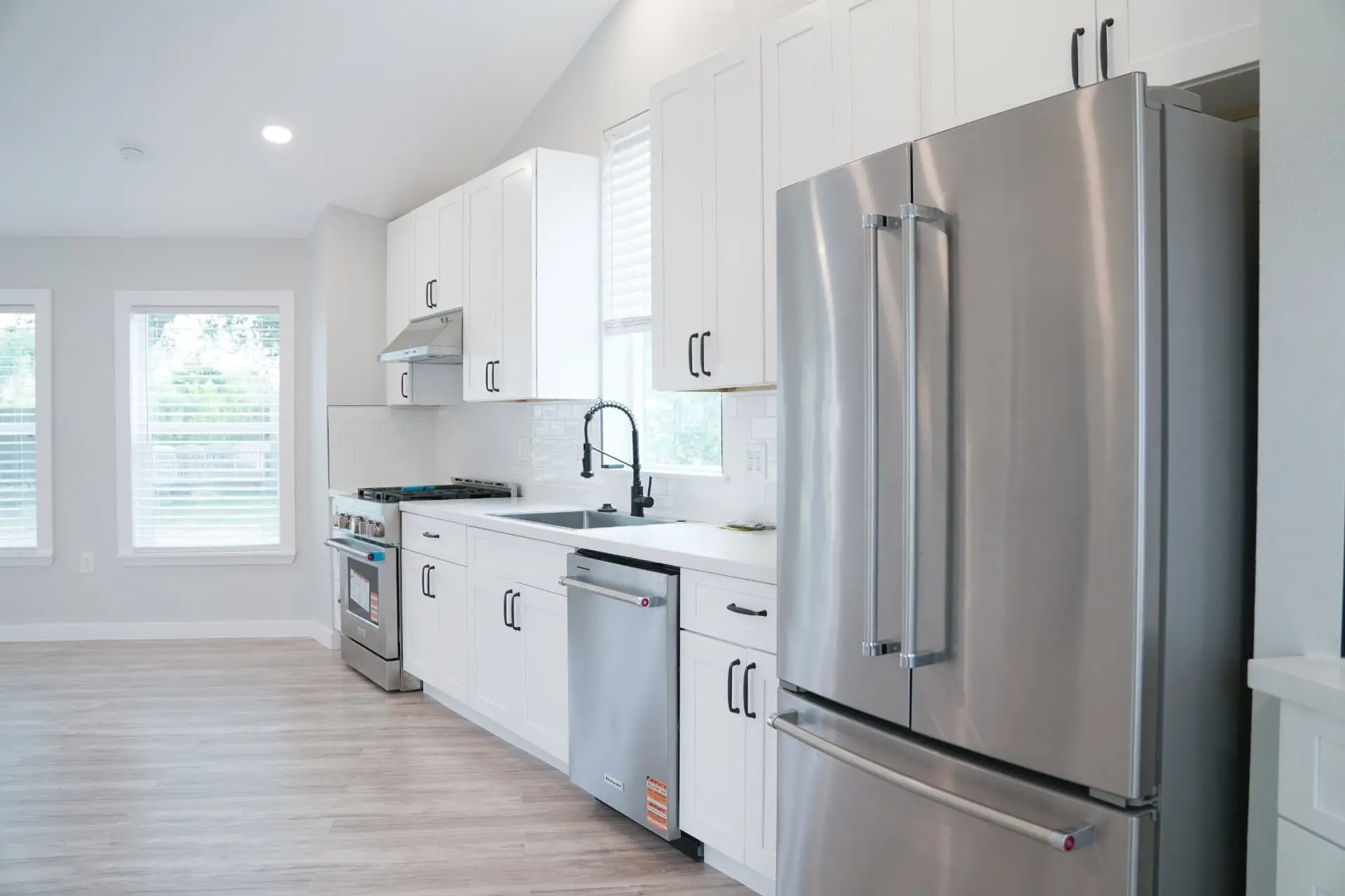 Full kitchen with stainless appliances and shaker cabinetry