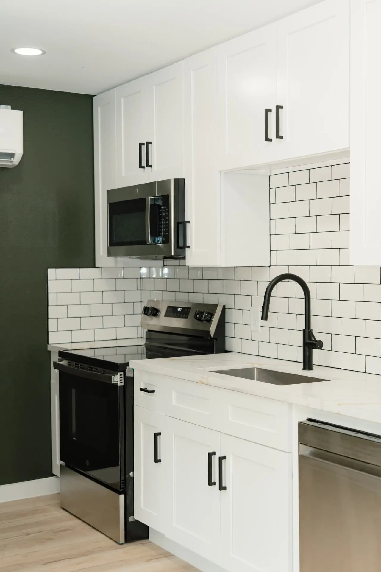 Kitchen with white shaker cabinets and subway tile backsplash
