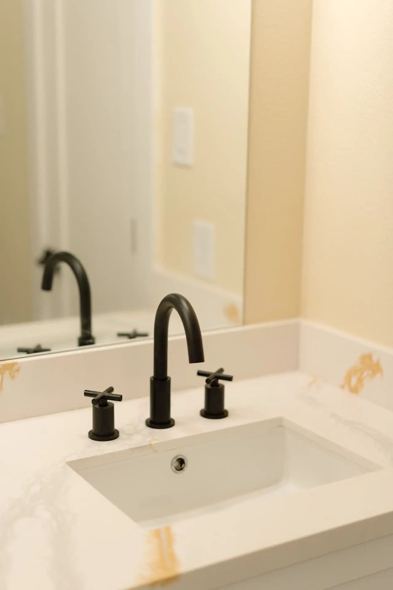 Quartz vanity with matte black widespread faucet
