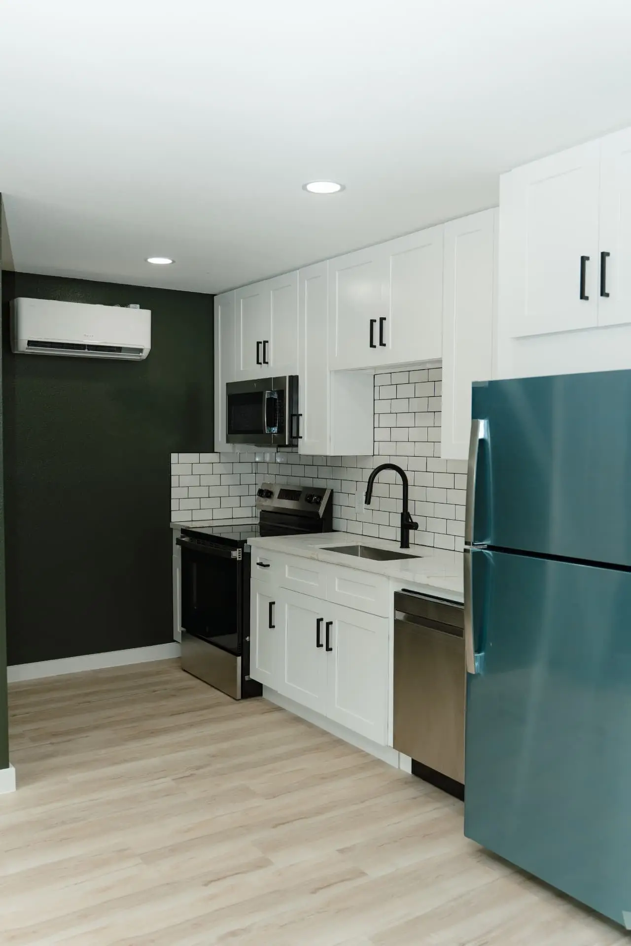 Kitchen with mini-split HVAC and full appliance package